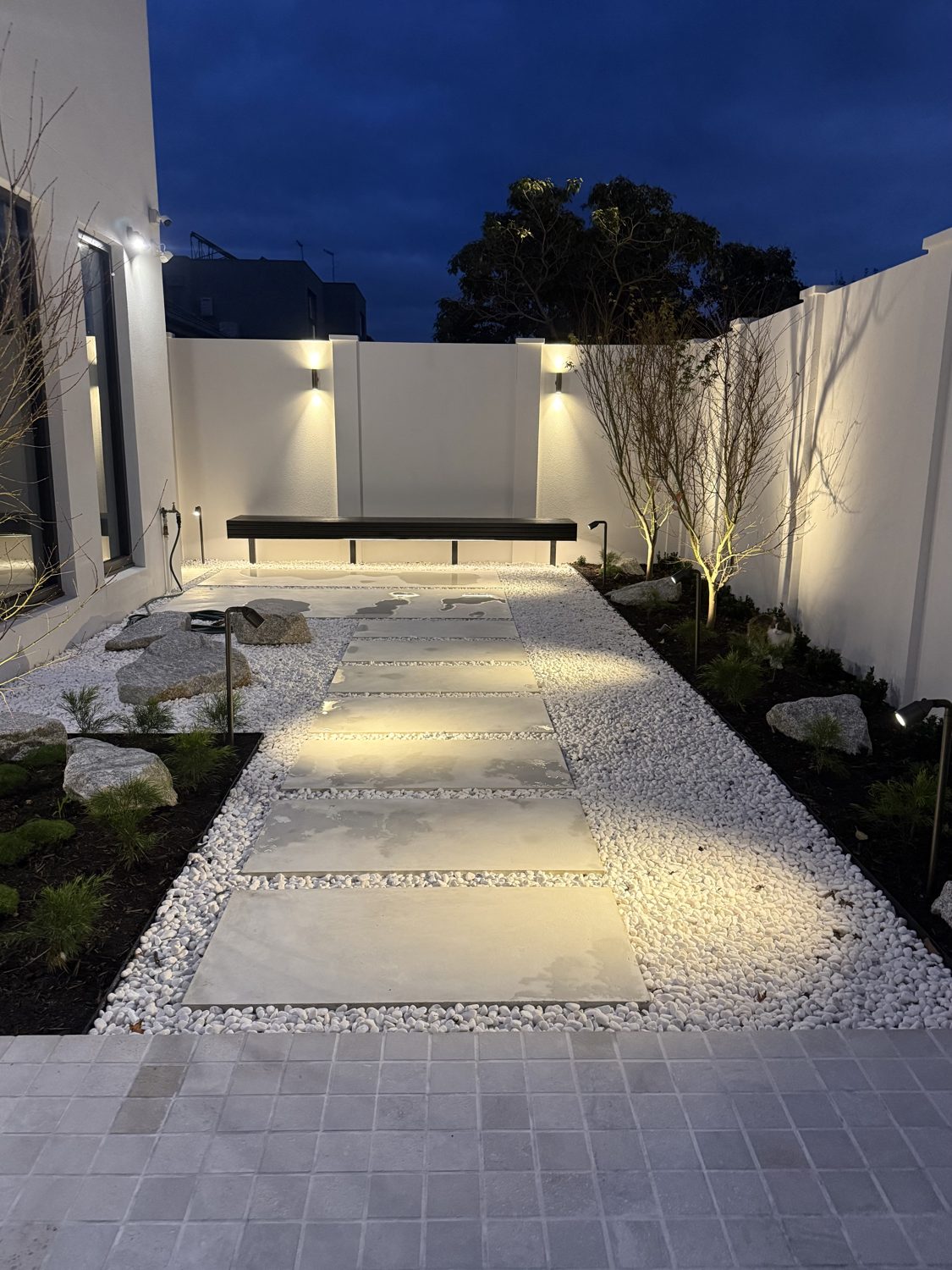 Garden path stepping stone and wall lighting installation